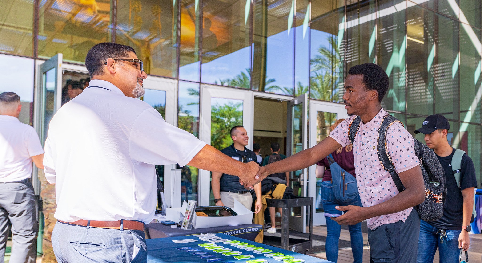 Undergraduate student Adrian Ssenyondo from Kampala, Uganda majoring in Aerospace Engineering talking to a member of the Department of Defense for information at the DoD Networking Event. 